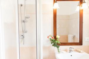 a bathroom with a sink and a shower with a mirror at Orlando Bayview in Balestrate +38 photos
