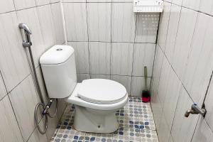 a small bathroom with a toilet in a stall at Homestay Zahra Syariah Gunung Dempo Mitra RedDoorz in Lahat