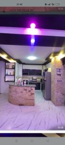 a room with a purple light on the ceiling at Saket plage in Bejaïa