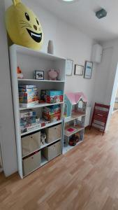 a childs room with a book shelf filled with books at Blues Hostel in Konin