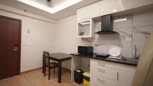 a kitchen with a table and a counter top at AS Suites in Cochin