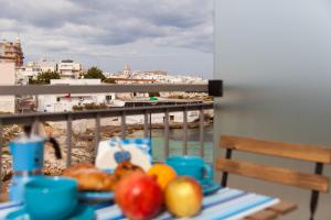 a table with fruit on a balcony with a view at B&B Portorosso in Monopoli