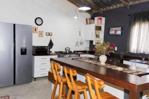 a kitchen with a large wooden table and chairs at Ses'fikile in Mayfern