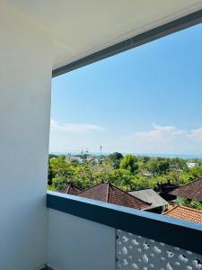 a window with a view of a city at Ulu Khandra Homestay in Bingin Beach