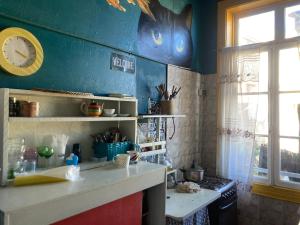 a kitchen with a counter and a clock on the wall at Don Ponchó in Valparaíso