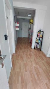 a hallway with a hard wood floor in a room at Blues Hostel in Konin