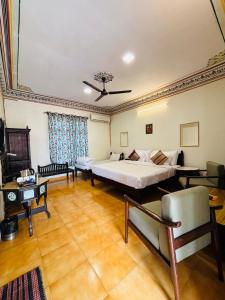 a large room with a bed and a couch at Sajjan Bagh Resort in Pushkar