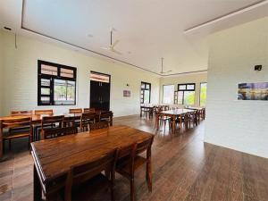 a dining room with wooden tables and chairs at Sajjan Bagh Resort in Pushkar