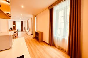 a kitchen and living room with a large window at Living Funchal X in Funchal