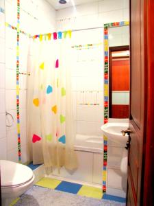 y baño con cortina de ducha y aseo. en Guest House On Abdulliny Street 54 en Almaty