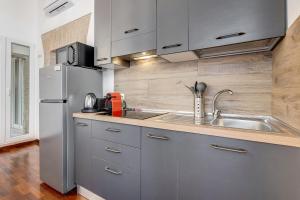 a kitchen with a stainless steel refrigerator and a sink at StarHome Colosseo in Rome +38 photos