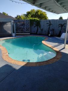 a swimming pool in a backyard with a fence at Le Monye in Lewisville