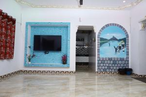 a room with a blue door and a painting on the wall at valparai home STAY LLHS in Vālpārai +9 photos