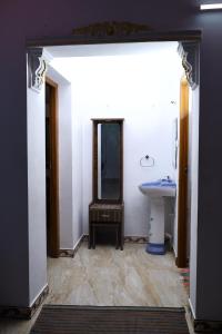 a bathroom with a sink and a mirror at valparai home STAY LLHS in Vālpārai