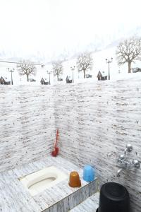 a bathroom with a sink in a brick wall at valparai home STAY LLHS in Vālpārai