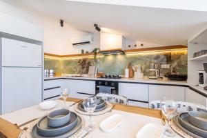 a kitchen with a table with plates and wine glasses at Vera home in Marmaris