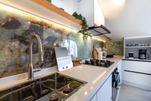 a kitchen with white counters and a sink at Vera home in Marmaris +36 photos