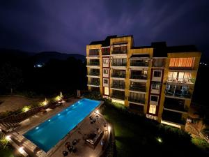 an overhead view of a hotel with a swimming pool at night at Saanjh-Kudrats Nilaya in Canacona
