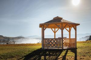 a gazebo in the middle of a field at Apartmán Family s výhľadom na Choč in Lúčky +31 photos