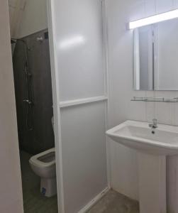 a white bathroom with a sink and a toilet at Pearl Crown Paradise room to rent Negombo in Negombo
