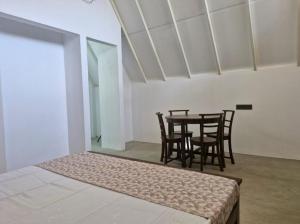 a dining room with a table and chairs in a room at Pearl Crown Paradise room to rent Negombo in Negombo