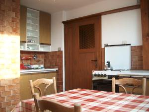 a kitchen with a table and chairs and a kitchen with a stove at Apartmán Trans Žamberk in Golčŭv Jeníkov