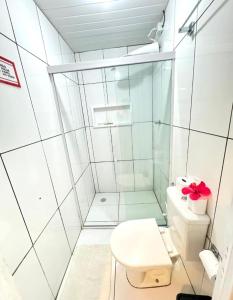 a white bathroom with a toilet and a shower at O Paraíso Mar de Vênus in Fernando de Noronha