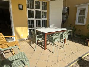 a table and chairs sitting on a patio at Palmar Bay - Beachside Villa in Palmar