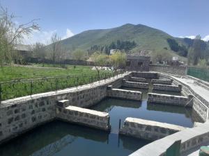 a pool of water in a river with mountains in the background at Агарод in Atʼarbekyan +2 photos