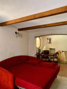 a bedroom with a red bed and a living room at Villa Giannina in San Giorgio di Piano