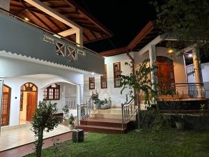 a house with stairs and doors and a porch at Kashmir villa in Galle