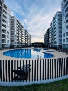 a large swimming pool in the middle of some buildings at Condominio Ricaurte in Ricaurte