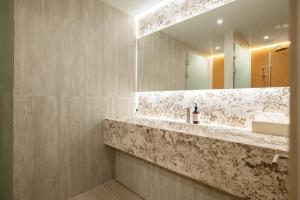 a bathroom with a sink and a mirror at THE EXTAY Lounge Jongno in Seoul +68 photos