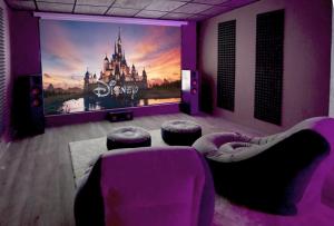 a room with a large poster of disney at Envia Golf Villa with private Pool, Garden and Cinema in Vícar