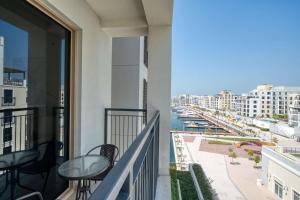 a balcony with chairs and a view of the ocean at PVH - Breezy 1BR with Partial Sea View - La Sirene in Dubai