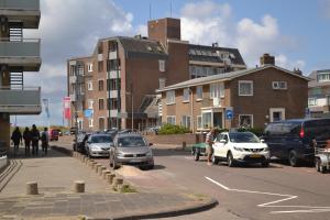 a street with cars parked on the side of the road at Ferienhaus Glücklich am Meer 1 mit Wellnesszugang in Egmond aan Zee