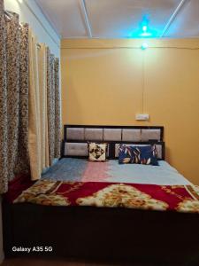 a bedroom with a bed in a room with curtains at Izna's stay in Nainital