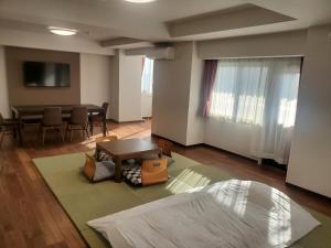 a living room with a table and a dining room at City Pension Zem in Tokyo