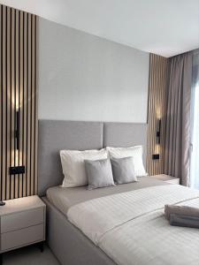 a bedroom with a large bed with white pillows at Premium Alicante in Gran Alacant