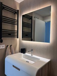 a bathroom with a white sink and a mirror at Premium Alicante in Gran Alacant +6 photos
