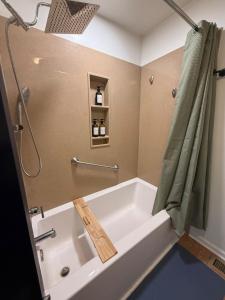 a bath tub in a bathroom with a shower at The Float House at Buckeye Lake - Hot Tub - Patio - Privacy in Thornville +38 photos