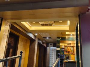 a hallway of a building with a gold ceiling at Hotel Shubham Inn in Thane