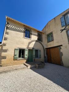 a large building with a door and a garage at Domaine Les Salices in Azille