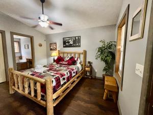 a bedroom with a wooden bed with red pillows at Hidden Love in Gatlinburg