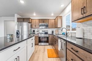 a kitchen with wooden cabinets and stainless steel appliances at Spacious 5BR - Gamer Room - Hot Tub & Basketball in Star