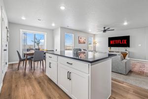 a kitchen and living room with a table and a couch at Spacious 5BR - Gamer Room - Hot Tub & Basketball in Star +36 photos