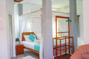 a bedroom with a bed and a bunk bed at PEACEFUL GREEN VILLA in Unawatuna