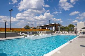 a large swimming pool with chairs and a building at Luxury Hideout in Decatur
