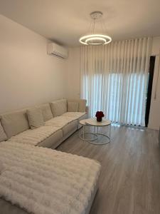 a living room with a couch and a table at Modern 2BR Near City Ring & Main Road Access in Tirana