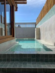 a swimming pool in a house at Marlim-azul Loft in Prado